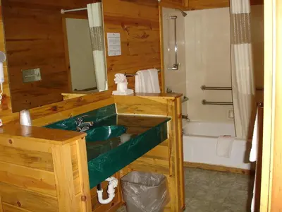 a bathroom with a green sink and a tub at Georgetown Mountain Inn in Georgetown