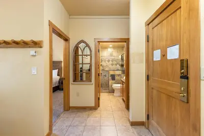 a hallway with a bathroom with a toilet and a door at 8115 Arapahoe Lodge condo in Keystone