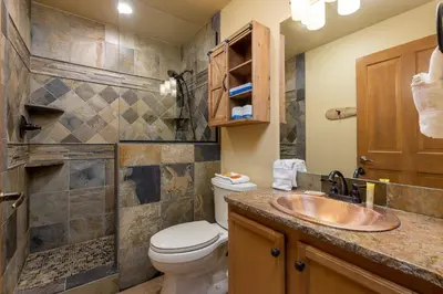 a bathroom with a toilet and a sink at 8115 Arapahoe Lodge condo in Keystone