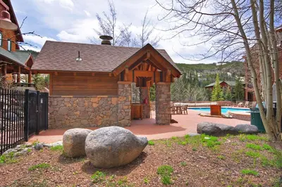 a house with a swimming pool and a building at 8115 Arapahoe Lodge condo in Keystone