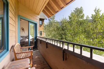 a porch of a house with a bench on it at 8115 Arapahoe Lodge condo in Keystone