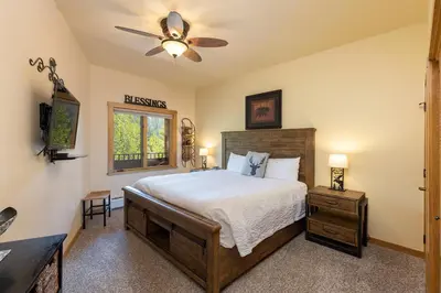 a bedroom with a bed and a ceiling fan at 8115 Arapahoe Lodge condo in Keystone