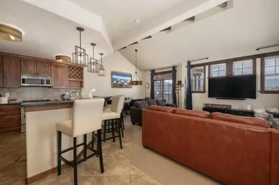 a kitchen and living room with a couch and a bar at Cozens Pointe B-301 condo in Fraser