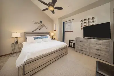a bedroom with a bed and a flat screen tv at Cozens Pointe B-301 condo in Fraser