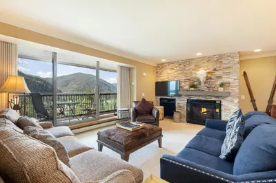a living room with a couch and a fireplace at 2534 Saints Johns condo in Keystone