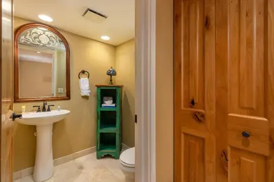 a bathroom with a sink and a toilet and a mirror at 2534 Saints Johns condo in Keystone