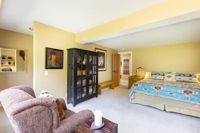 a bedroom with a bed and a couch and a chair at 2534 Saints Johns condo in Keystone