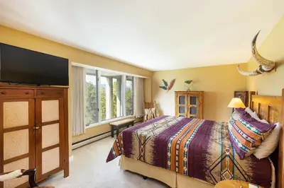 a bedroom with a bed and a flat screen tv at 2534 Saints Johns condo in Keystone