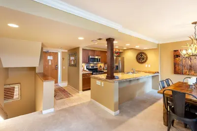 an open kitchen and dining room with a dining table at 2534 Saints Johns condo in Keystone