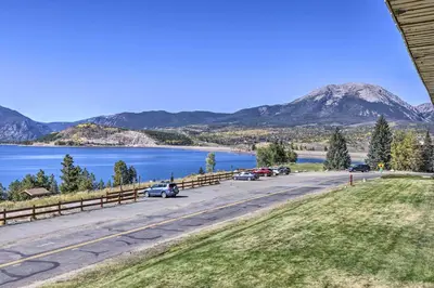 a road with a lake and mountains in the background at 8 Mi to Keystone Resort Dillion Condo with Hot Tub! in Dillon