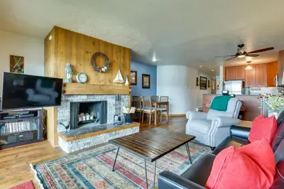 a living room with a couch and a fireplace at 8 Mi to Keystone Resort Dillion Condo with Hot Tub! in Dillon