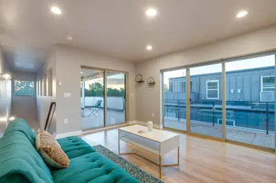 a living room with a blue couch and a table at Heated Rooftop Deck and Mtn Views Denver Retreat in Englewood