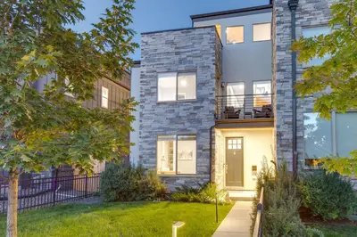 an exterior view of a house with a stone facade at Heated Rooftop Deck and Mtn Views Denver Retreat in Englewood