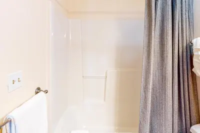 a bathroom with a tub and a shower curtain at WinterStar E-2 in Fraser