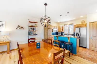a kitchen and dining room with a wooden table and chairs at WinterStar E-2 in Fraser
