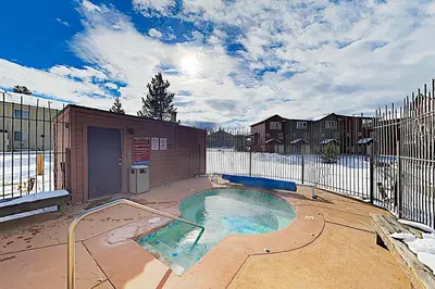 a swimming pool in a yard with a fence at WinterStar E-2 in Fraser