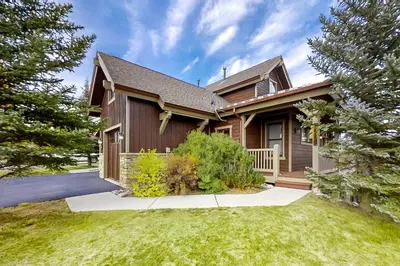a house with a fence and a yard at Mountain Sky in Granby