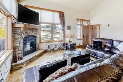 a living room with a couch and a fireplace at Mountain Sky in Granby