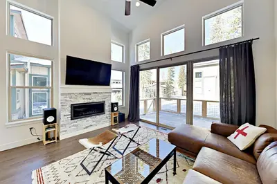 a living room with a couch and a tv at Mountain Sky Cottage in Fraser