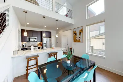 a dining room and kitchen with a glass table and chairs at Mountain Sky Cottage in Fraser