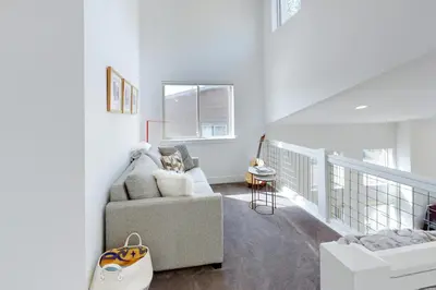 a white living room with a couch and a chair at Mountain Sky Cottage in Fraser