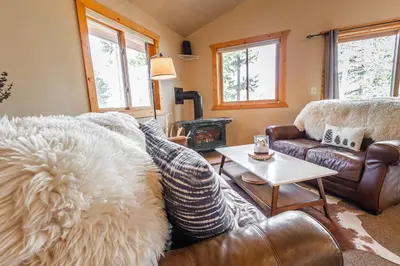 a living room with a couch and a table at Mountain Calling in Grand Lake