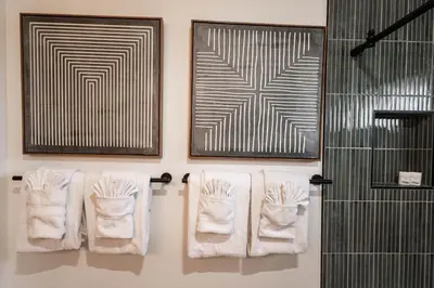 a bathroom with white towels on a rack and a shower at Mountain Calling in Grand Lake