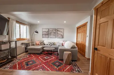 a living room with a couch and a table at Mountain Calling in Grand Lake