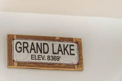 a sign that reads grand lake on a wall at Mountain Calling in Grand Lake