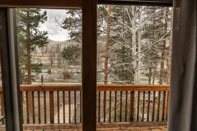 a view from a screened in porch with a window at Mountain Calling in Grand Lake