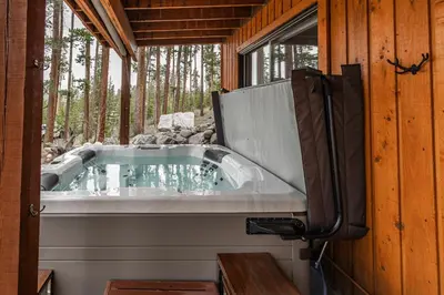 a jacuzzi tub sitting inside of a house at Mountain Calling in Grand Lake