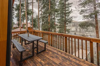 a wooden deck with a table and chairs on it at Mountain Calling in Grand Lake