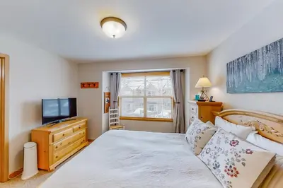 a bedroom with a bed and a television at Saw Mill Station 127 in Winter Park