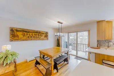 a kitchen with a wooden table and a dining room at Saw Mill Station 127 in Winter Park