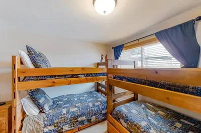 a bedroom with two bunk beds in a house at Saw Mill Station 127 in Winter Park