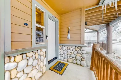 a front door of a house with a stone wall at Saw Mill Station 127 in Winter Park