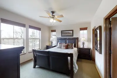 a bedroom with a bed and a ceiling fan at Deer Track Retreat in Granby