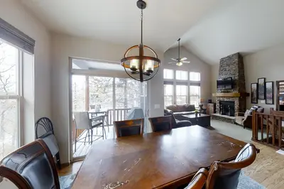 a dining room with a wooden table and chairs at Deer Track Retreat in Granby