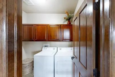 a small laundry room with a washer and dryer at Deer Track Retreat in Granby