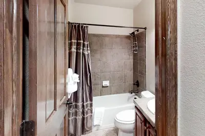 a bathroom with a toilet and a tub and a sink at Deer Track Retreat in Granby