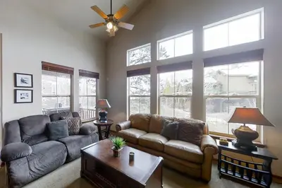 a living room with a couch and a table at Deer Track Retreat in Granby