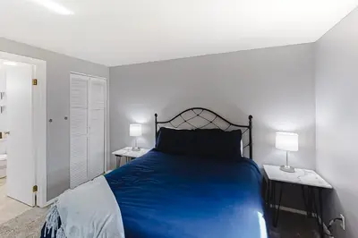 a bedroom with a blue bed and two lamps at Beaver Village 15-11 in Winter Park