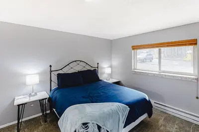 a bedroom with a blue bed and a window at Beaver Village 15-11 in Winter Park