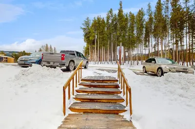 a wooden bridge in the snow with cars parked at Beaver Village 15-11 in Winter Park