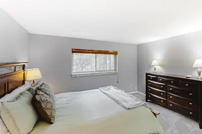 a bedroom with a bed and a dresser and a window at Beaver Village 15-11 in Winter Park