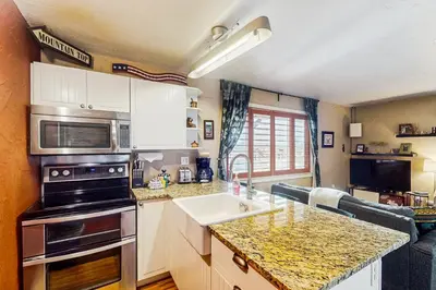 a kitchen with a sink and a stove at Winter Park Meadows Lodge in Fraser