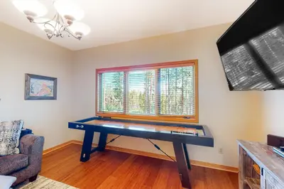 a ping pong table in a living room with a window at Big Bear Palace in Fraser