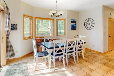a dining room with a table and chairs at Big Bear Palace in Fraser