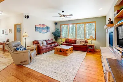 a living room with couches and a tv at Big Bear Palace in Fraser