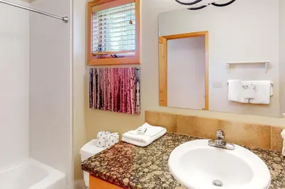 a bathroom with a sink and a tub and a mirror at Big Bear Palace in Fraser